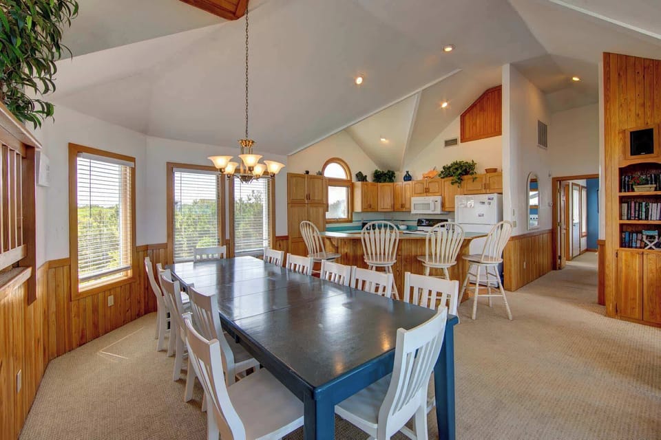 Expanded dining area seating 12 with a 4-person breakfast bar connected to the kitchen