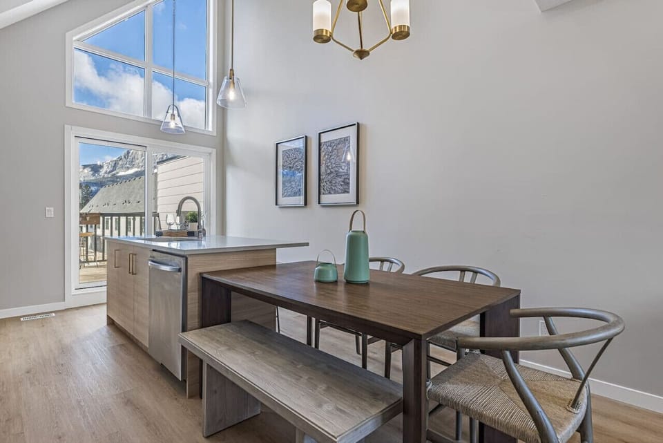 The high vaulted ceilings and carefully curated light fixtures create a space that feels bright and airy