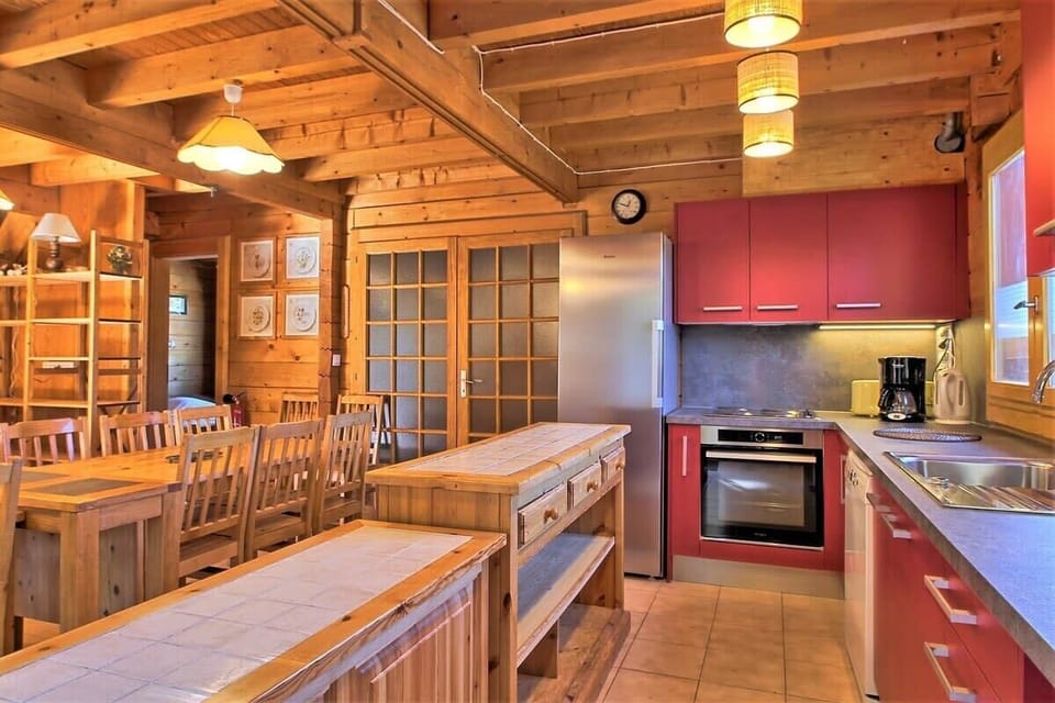The spacious and well-equipped kitchen boasts a large island with bar seating, perfect for informal meals or casual gatherings.  A full-sized refrigerator, oven, microwave, and dishwasher provide all the modern conveniences for preparing delicious meals. 