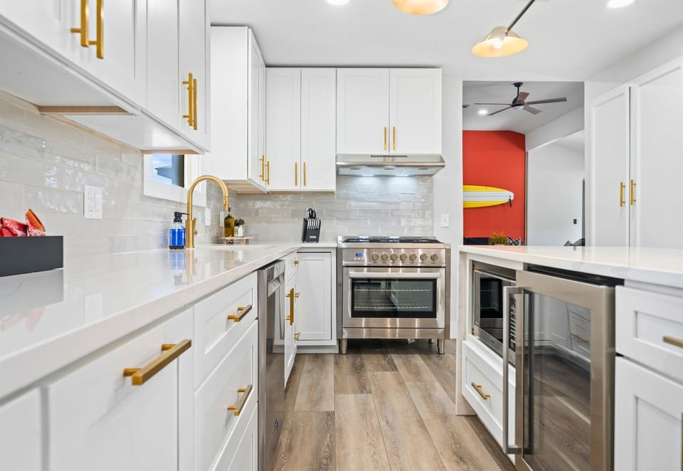 A closer look at the kitchen showcases the top-of-the-line appliances and sleek design—perfect for cooking up group meals.
