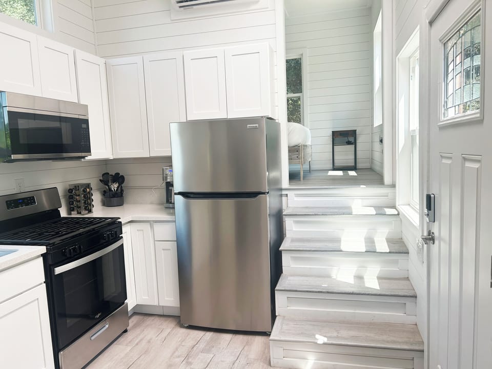 Full kitchen with sink, stove, microwave, dishwasher, refrigerator

