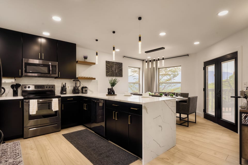 High-End Finishes, features black cabinetry, modern appliances