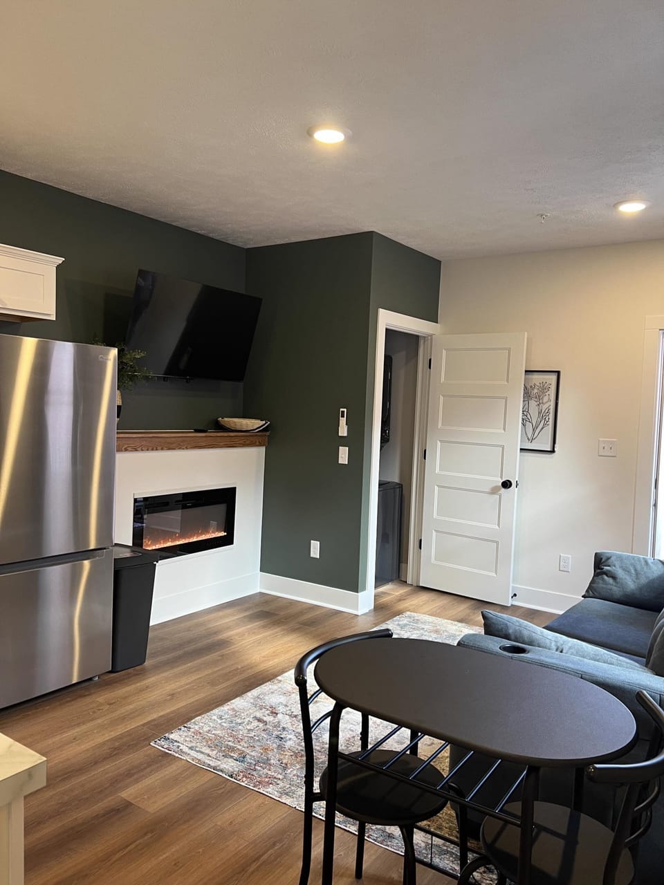 Urban Queen at the Victorian Unit D living area, kitchen, fireplace, 300 sq. ft.