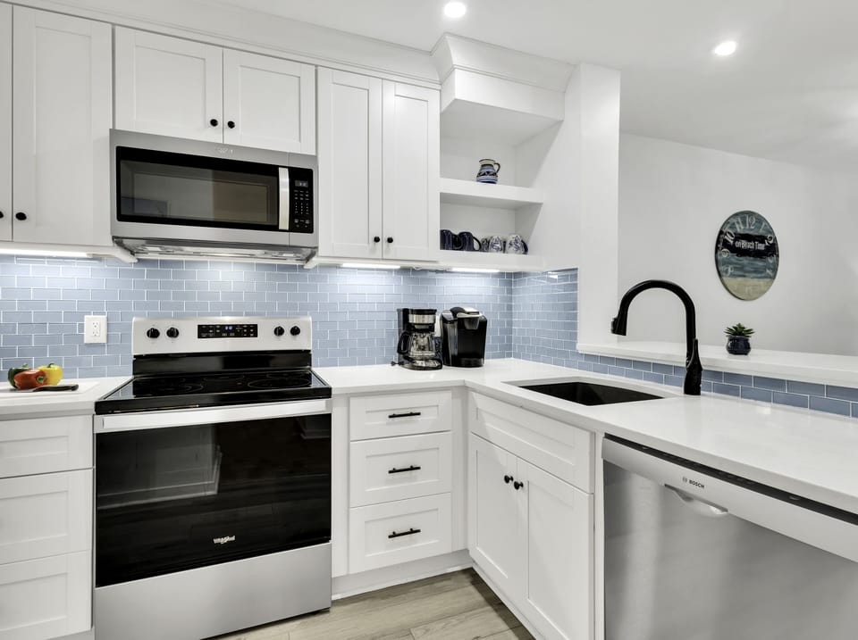 To your left from the entrance, a fully-equipped kitchen awaits, simplifying meal preparation.
