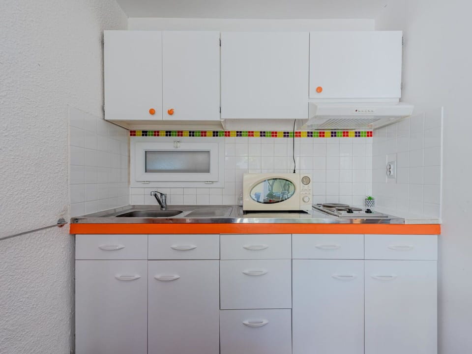 Cabinetry, Building, Kitchen Appliance, Kitchen, Kitchen Stove, Countertop, Home Appliance, Drawer, Major Appliance, Sink