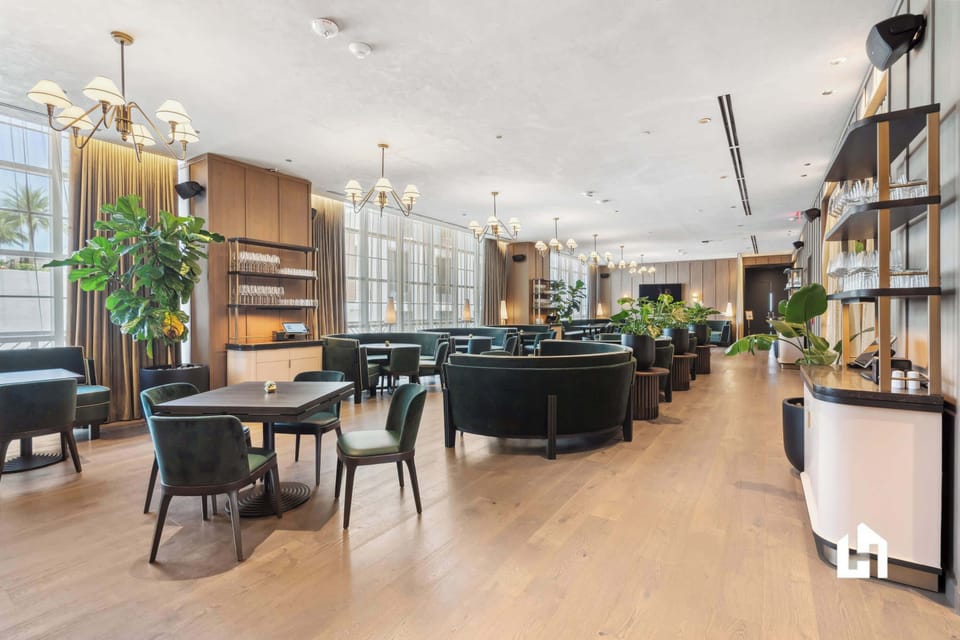 Unwind in our chic lounge: plush seating, natural light, and lush plants.
