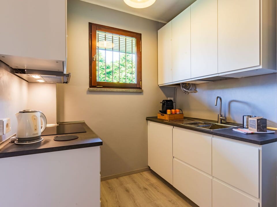 Property, Cabinetry, Kitchen Appliance, Kitchen, Countertop, Kitchen Stove, Lighting, Home Appliance, Window, Interior Design
