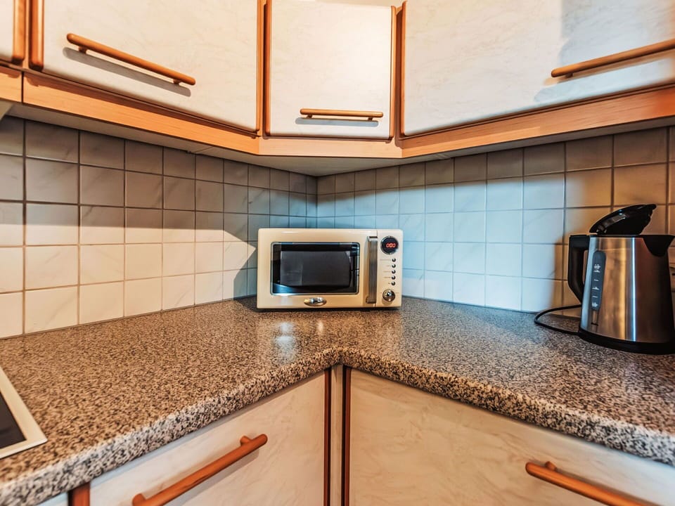 Cabinetry, Property, Building, Countertop, Wood, Interior Design, Lighting, Kitchen, Flooring, Floor