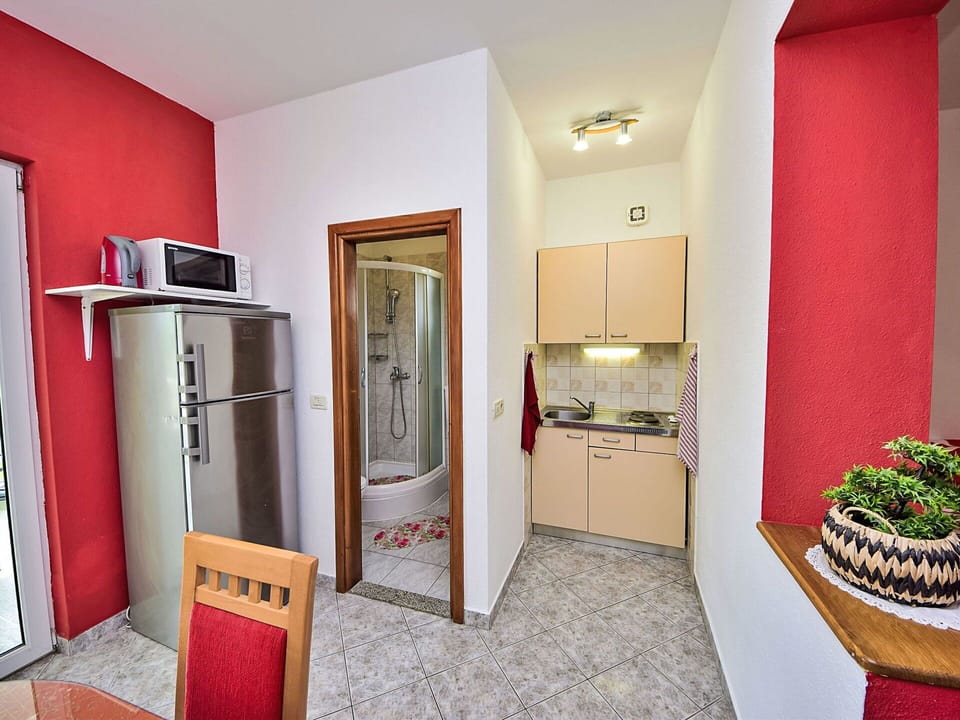 Property, Picture Frame, Wood, Cabinetry, Plant, Interior Design, Orange, Comfort, Floor, Flooring