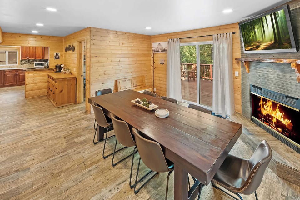 Plenty of seating for dining with fireplace and LCD Smart TV.