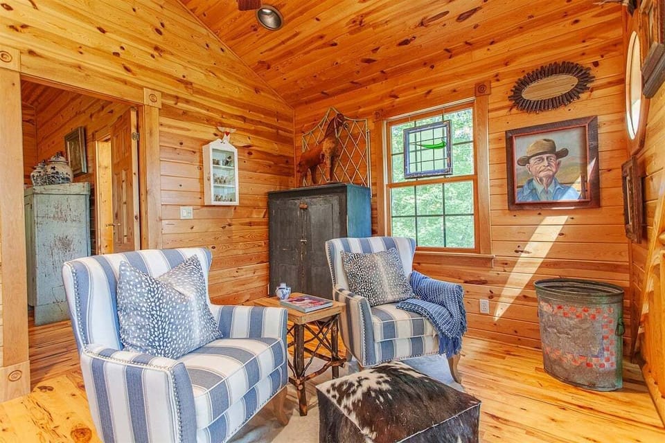 A-frame loft windows and vintage decor fill this bright cabin corner with mountain charm and personality.