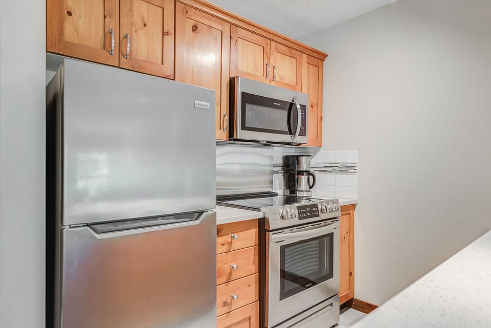 Modern kitchen with stainless steel appliances and ample counter space.