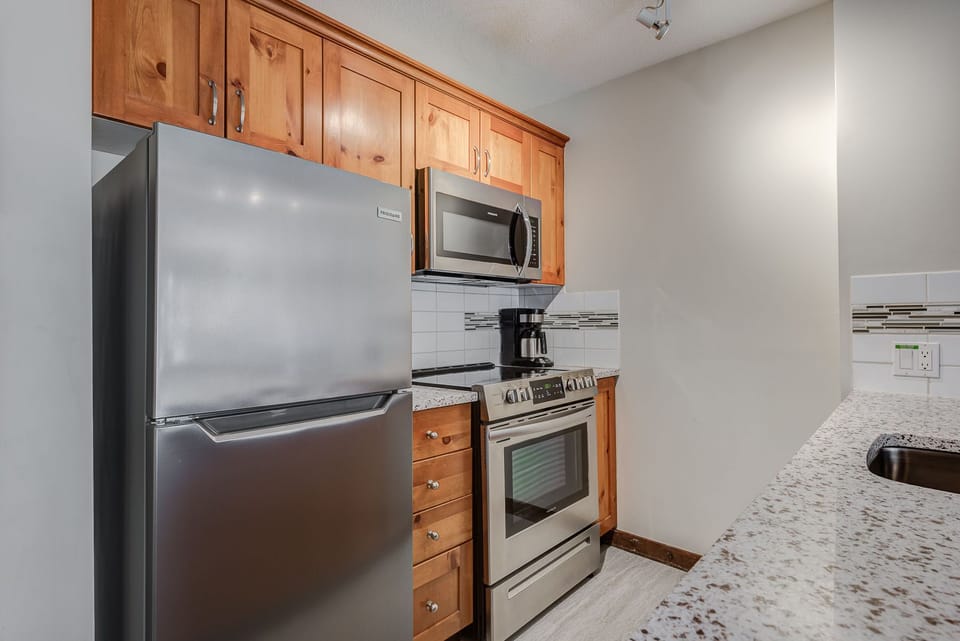 Modern kitchen with stainless steel appliances and ample counter space.
