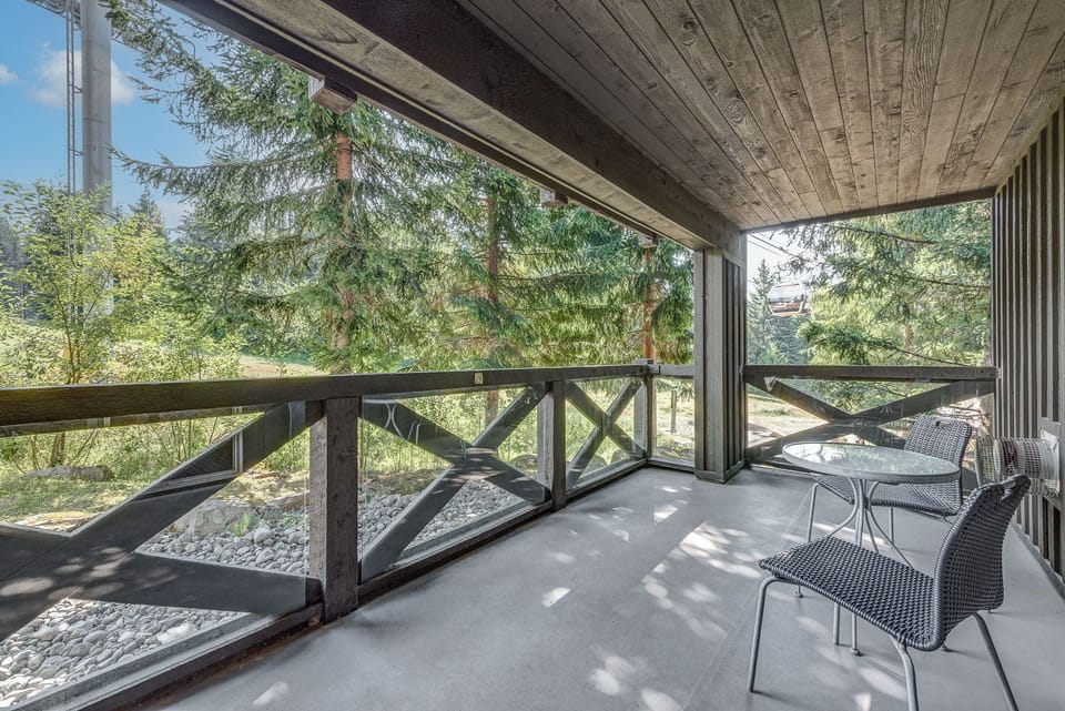 Private balcony with serene forest views, ideal for enjoying the outdoors.