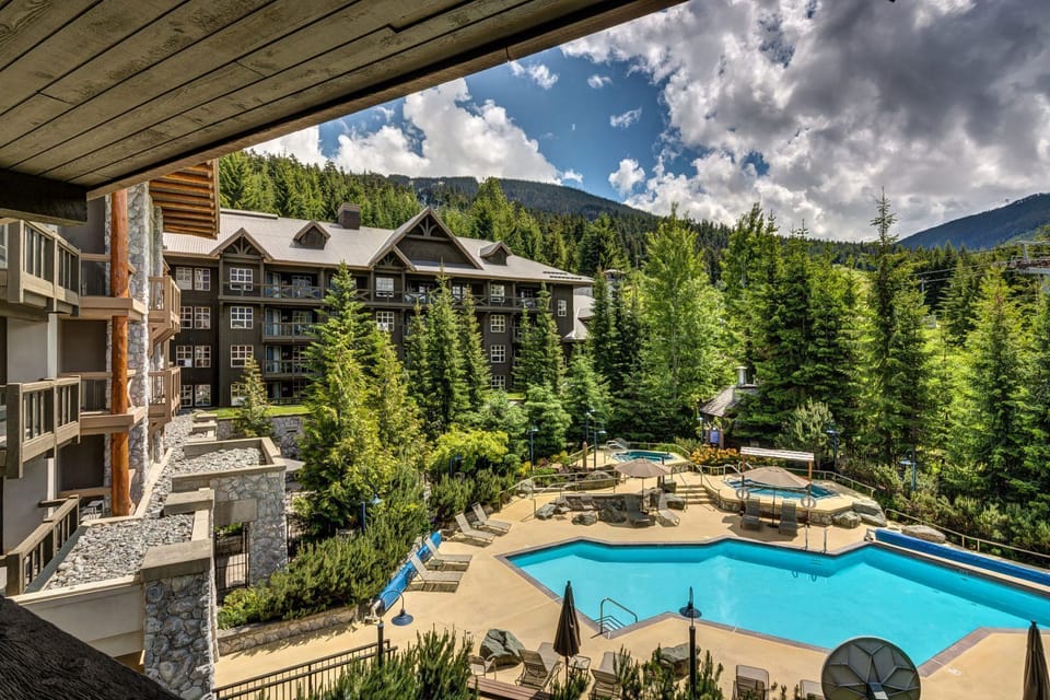 Outdoor pool surrounded by lush greenery—summer relaxation at its best.