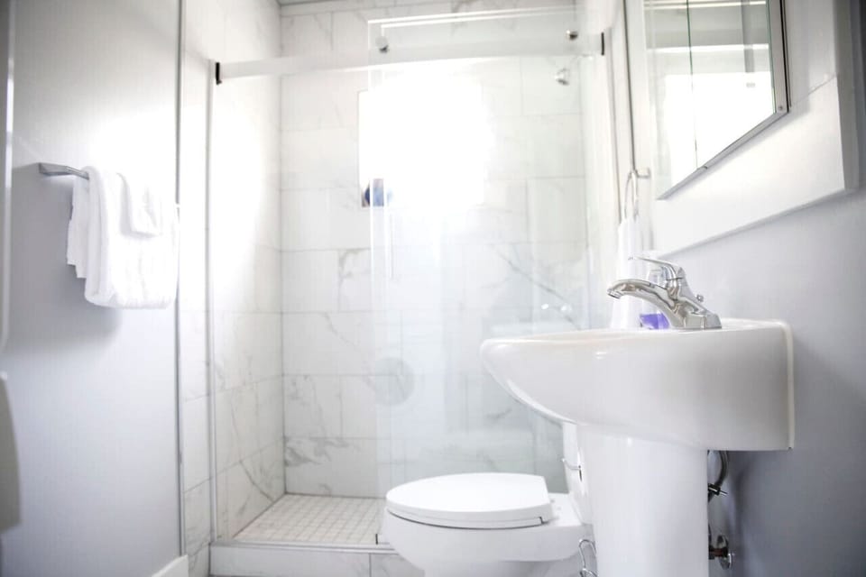 Bright and stylish bathroom with a sleek glass shower for a refreshing start to your day.