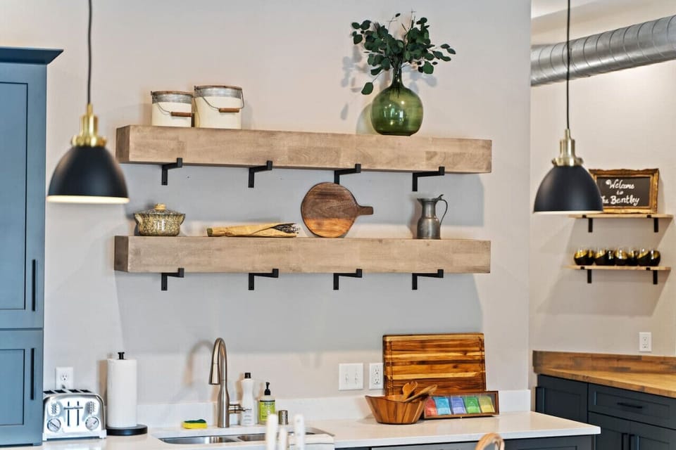 Close-up of the sleek kitchen, featuring beautiful open shelving and thoughtful design, creating a warm and functional space.`