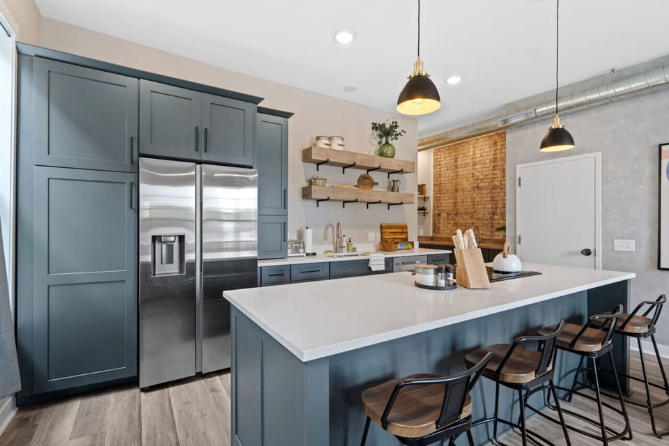 Modern kitchen with stainless steel appliances, offering an elegant and spacious area for preparing meals and enjoying good company.