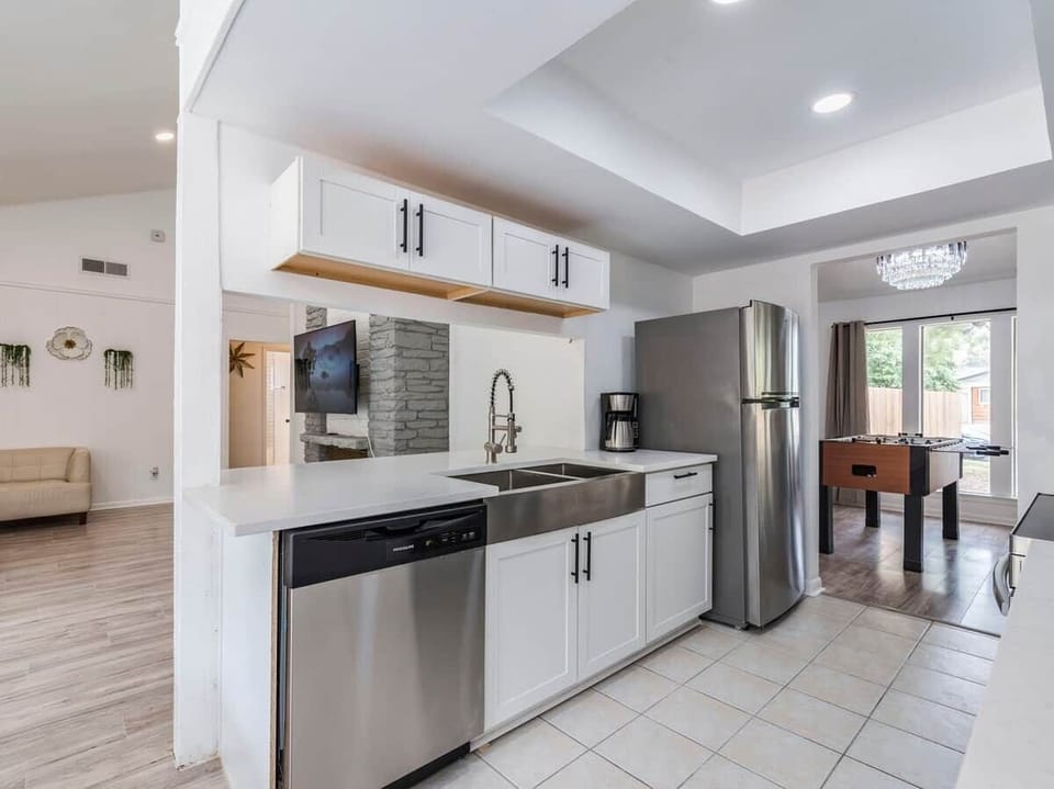 Kitchen has Dishwasher, Microwave, Refrigerator, Electric Stove, Oven, Dishware, Filter Coffee Maker. 