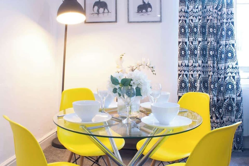 An inviting dining with a complete set of dining wares provided.
