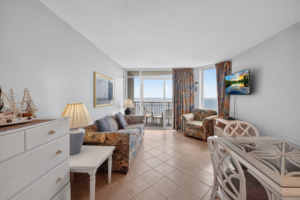 Living Room - Unwind in the cozy living area with seating and entertainment after a fun day at the beach.