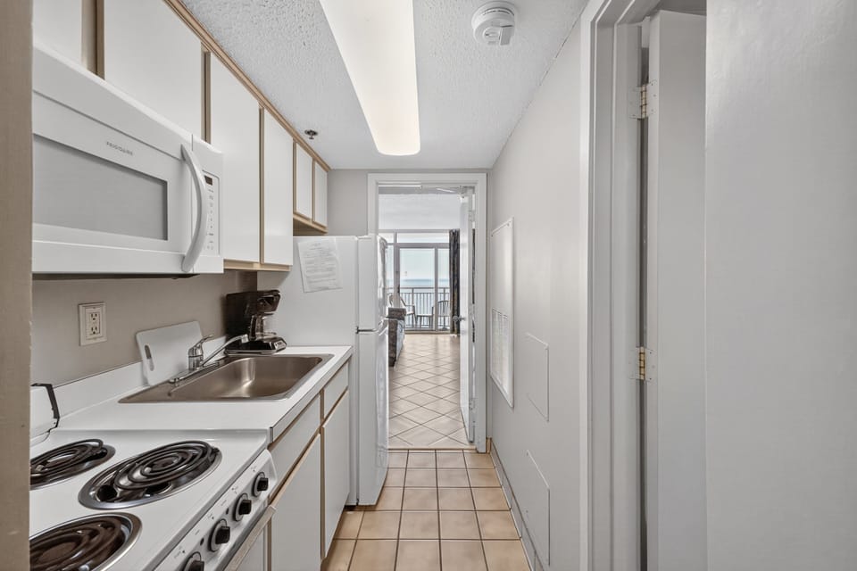 Kitchen - Prepare meals and snacks easily in the well‑equipped kitchen with modern appliances and cookware.
