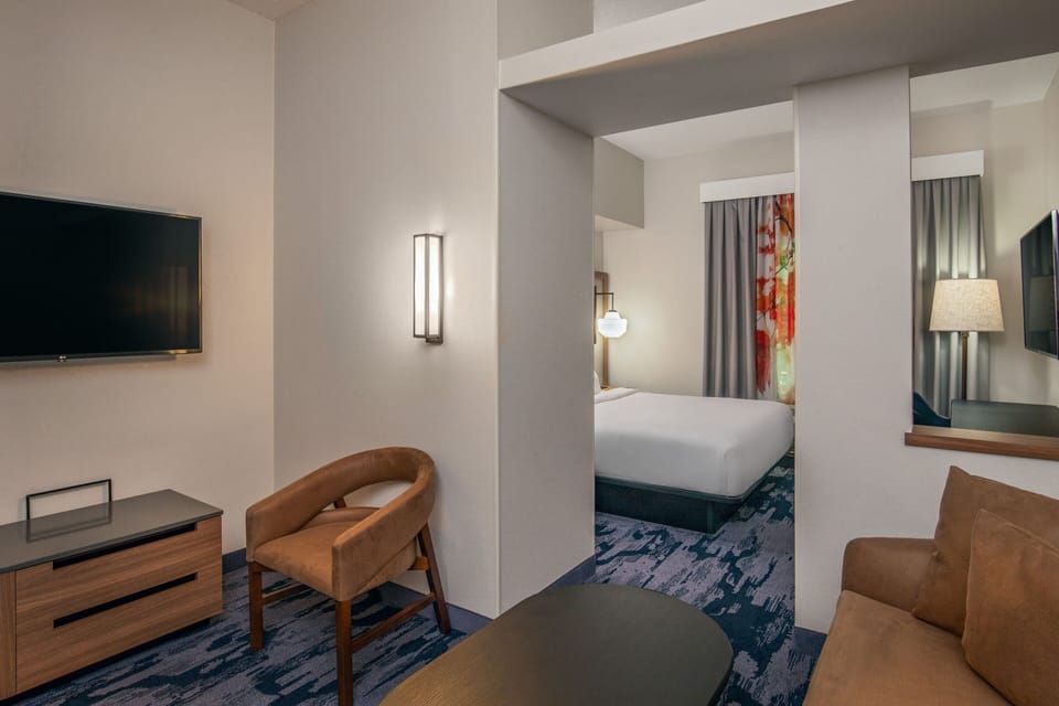 Premium bedding, desk, laptop workspace, blackout drapes