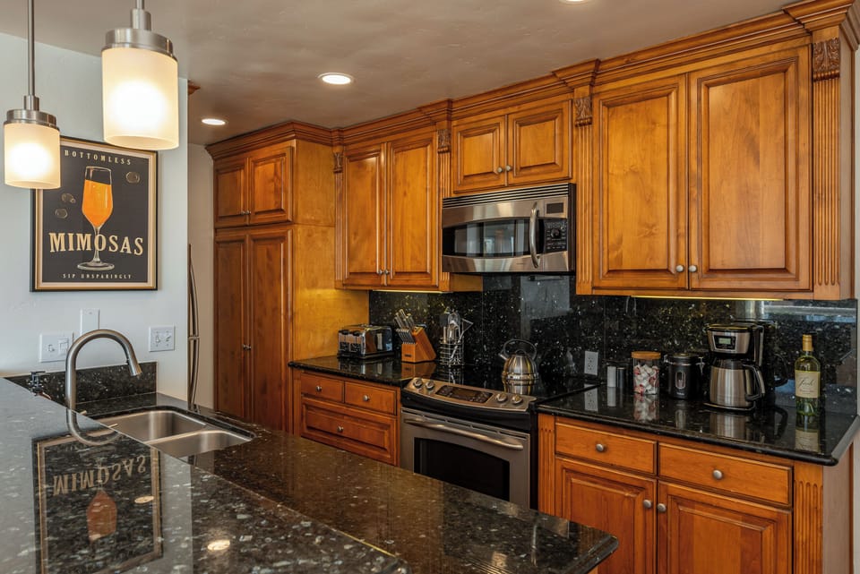 Full kitchen with coffee maker, blender, toaster, dishwasher, and basics