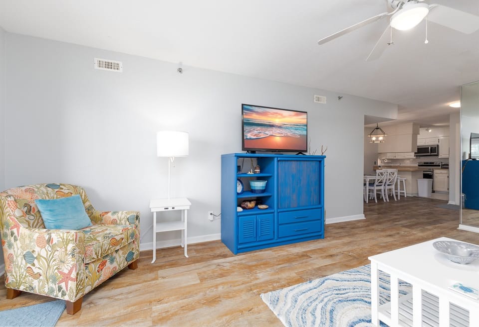 Cozy living room with TV, coffee table, couch, and stylish decor