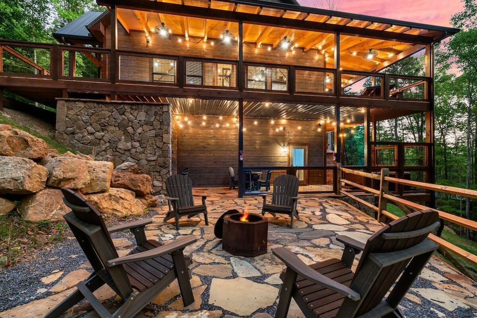 Pull up an Adirondack, let the fire get going, and watch the last light fade behind the cabin's three stories of string-lit decks. This is the moment the trip starts.
