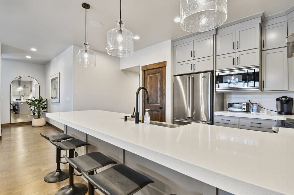 Seating for five at the kitchen island, where friends can visit and watch the chef prepare meals