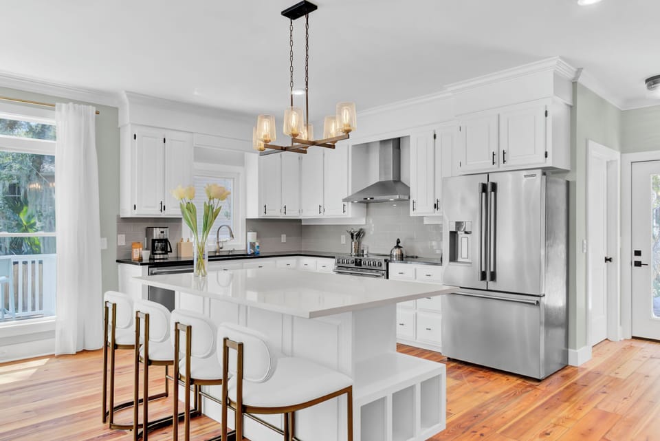 Kitchen features an island with barstool seating.