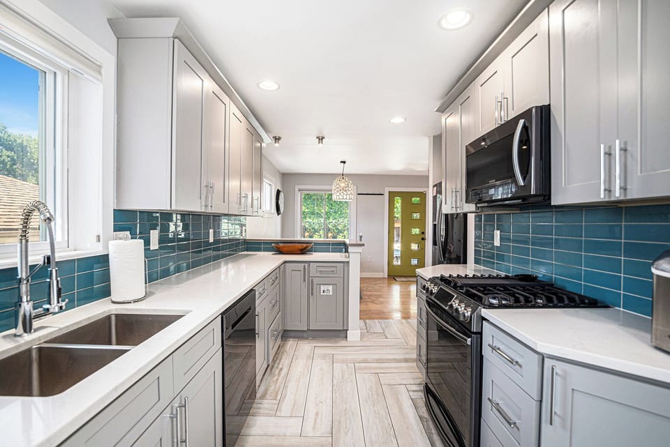 Modern kitchen with stainless steel appliances, ready for your culinary creations.