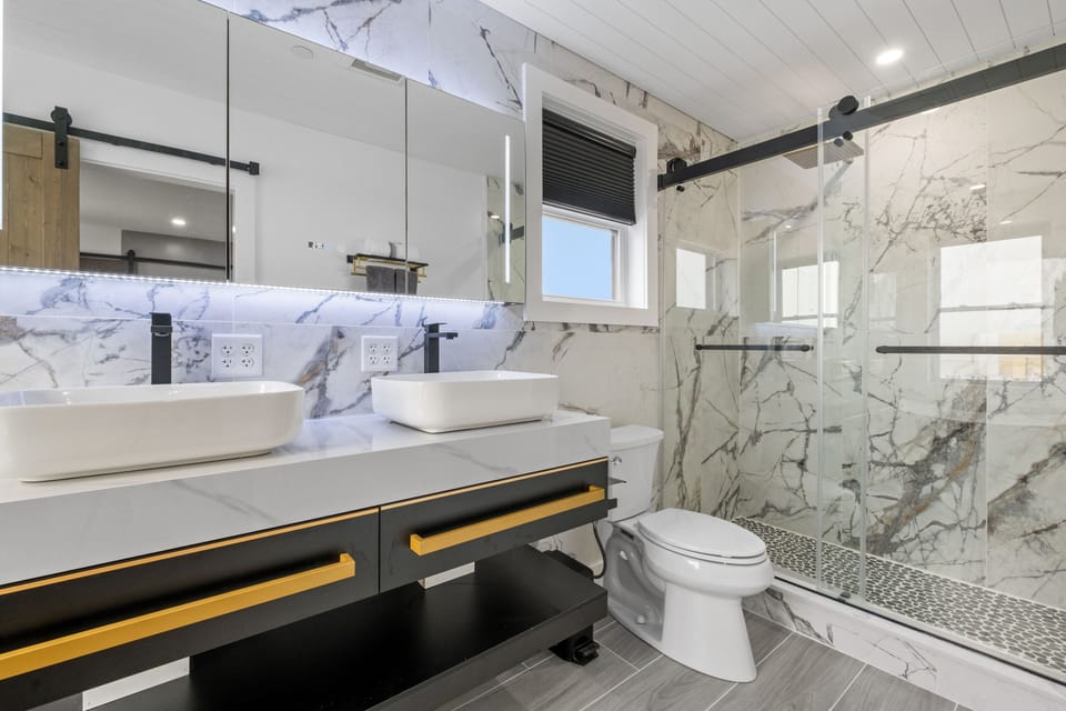 3rd floor primary bedroom en suite bathroom with double sinks and a walk-in shower