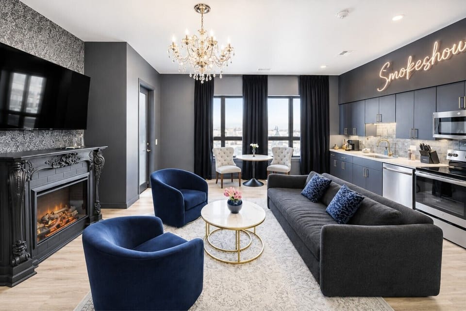 Open floor plan living and kitchen area with sofa bed and Smart TV