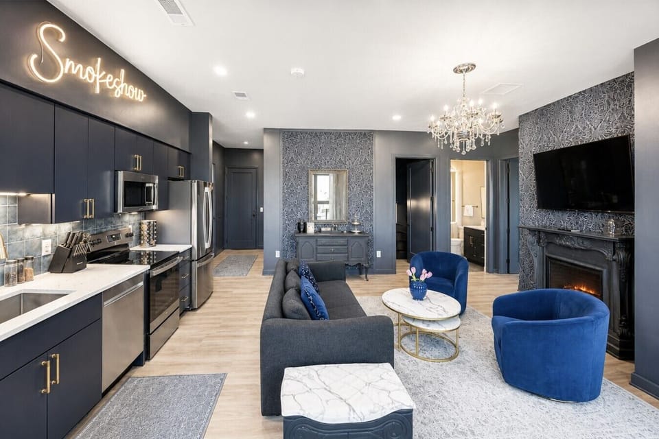 Open floor plan living and kitchen area with sofa bed and Smart TV