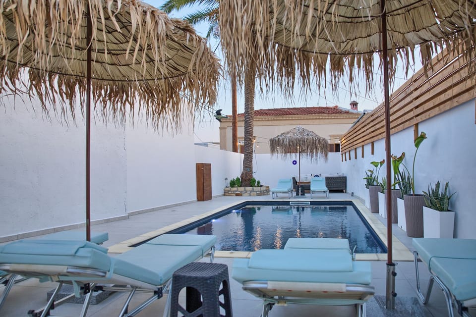 Umbrellas with sunbeds at the pool area