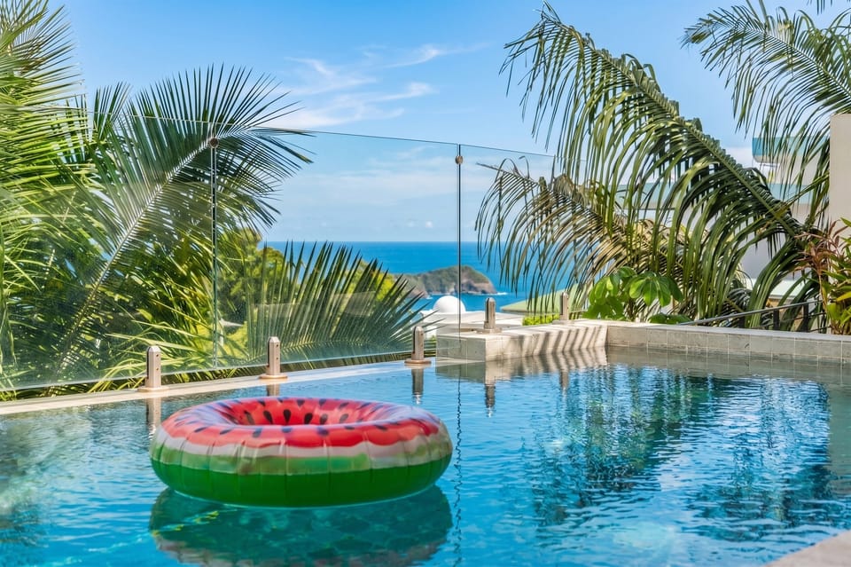 The infinity-edge pool blends seamlessly into the tropical horizon