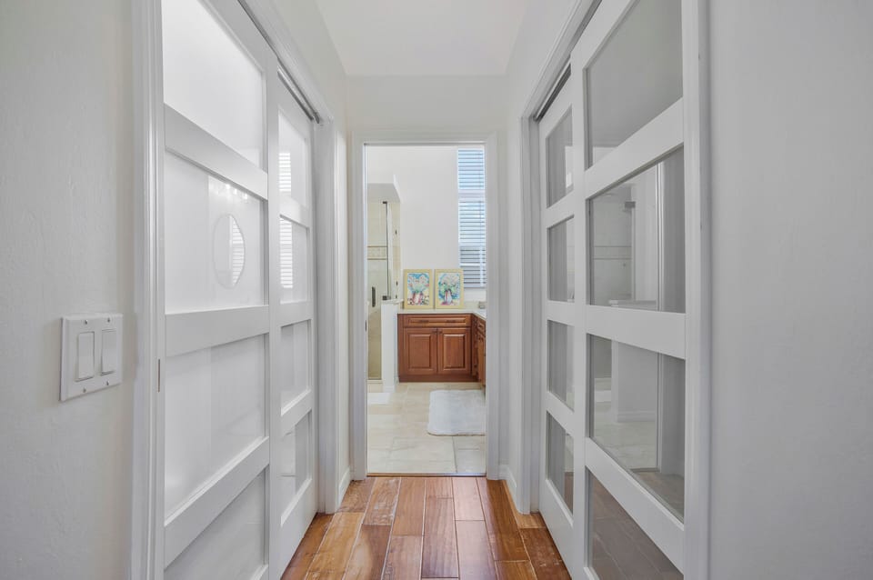 Walkway to the master bath with walk-in closet and storage