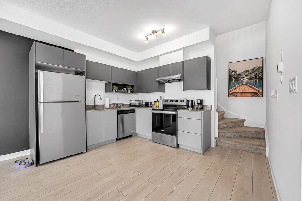 Unleash your inner chef in our fully equipped kitchen. Features professional stainless steel appliances, ample stone countertop space, and sleek custom cabinetry. We provide everything you need, from a quick breakfast to a full family feast.