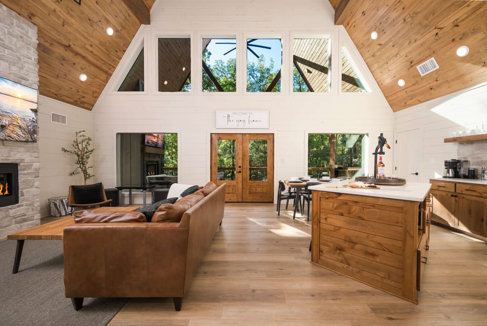 Inviting living room with fireplace, leather sofa, and wooden accents.