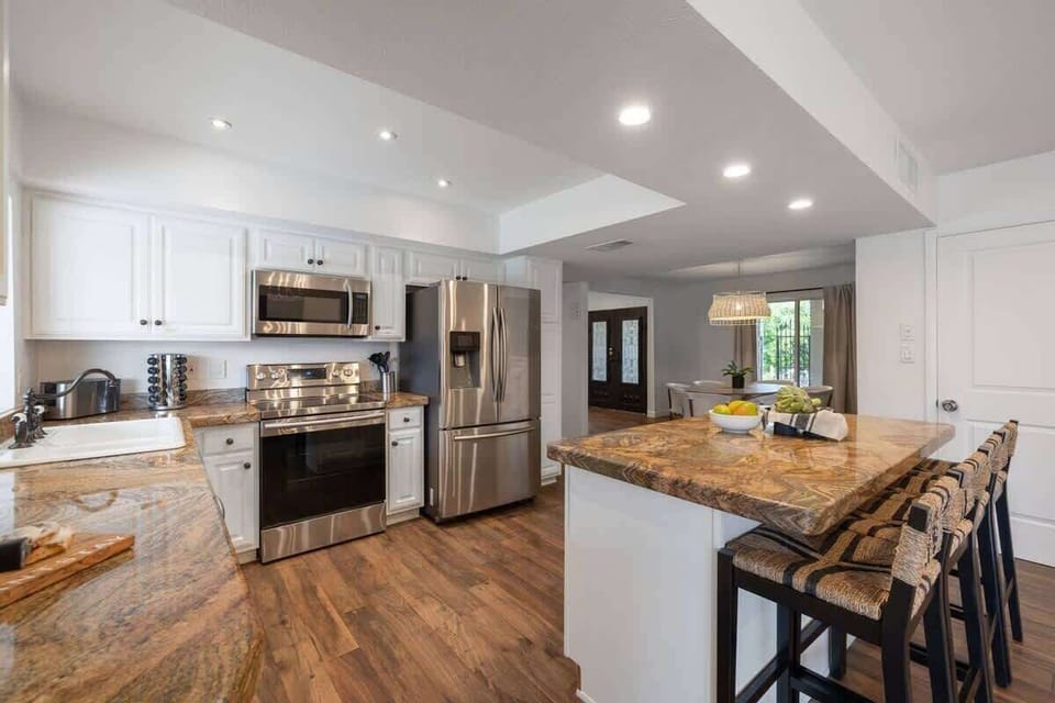 Spacious kitchen with barstool seating and tons of counter space.