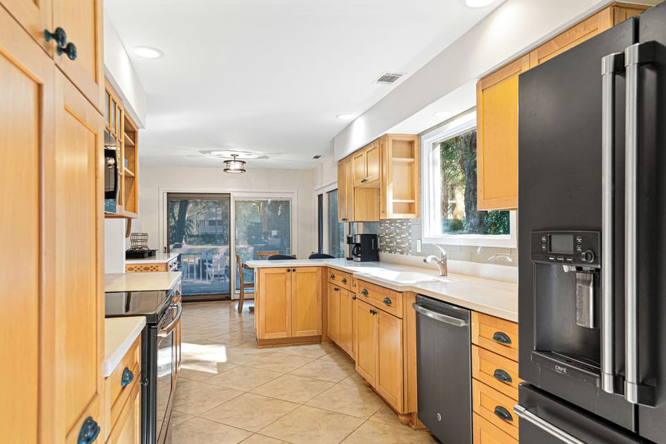 The open layout continues into a eat-in kitchen and formal dining room