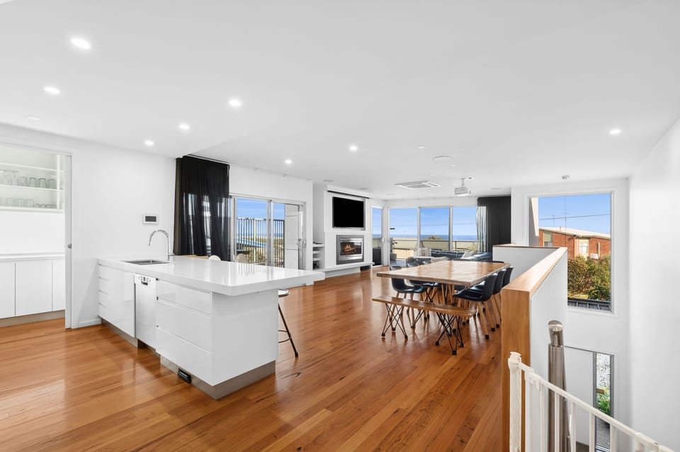 The main living area features expansive windows that bring in abundant natural light