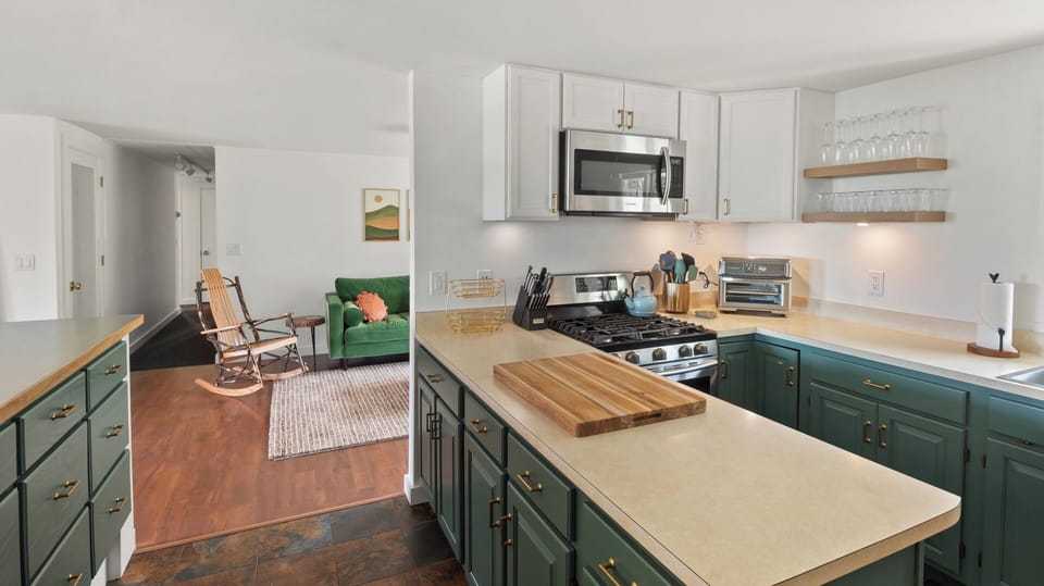 Beautiful kitchen leads into den area with Comfy couch and TV