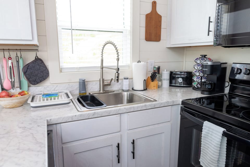 Kitchen with electric range and full size sink