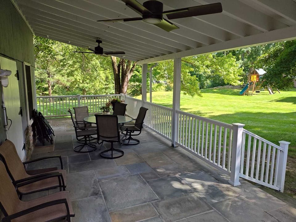 Large wrap-around covered porch with fans