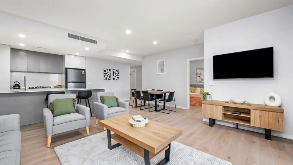 Open living zone combining lounge, dining, and kitchen areas for seamless everyday living.