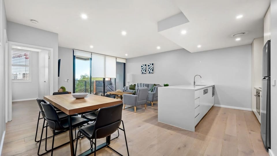 Six-seater dining table set within the spacious open-plan living area.