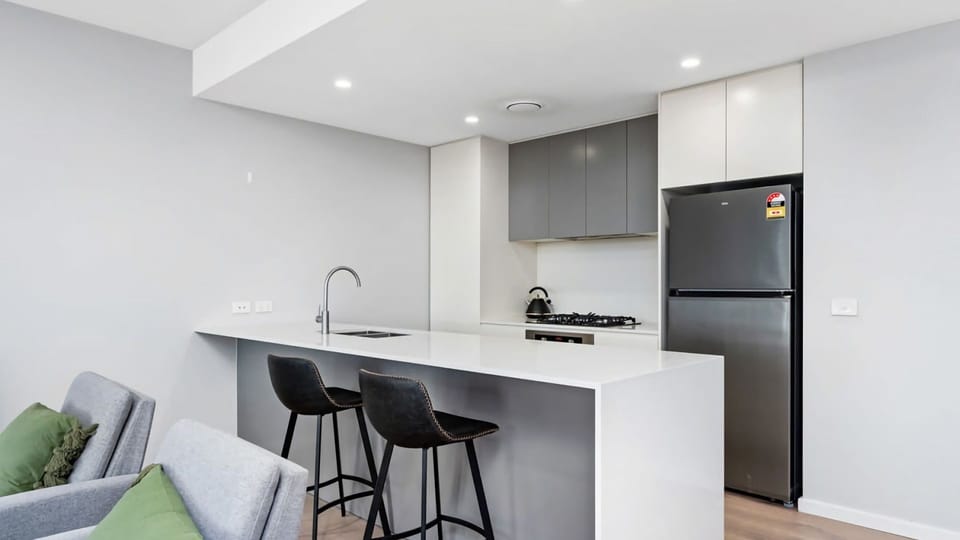 Fully equipped kitchen with oven, stovetop, microwave, and dishwasher.